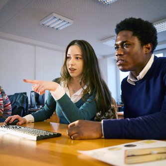 Schüler tauschen sich am Computer aus