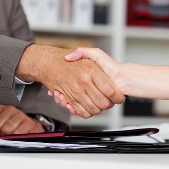 Vertragsabschluss zwei Menschen geben sich Hand