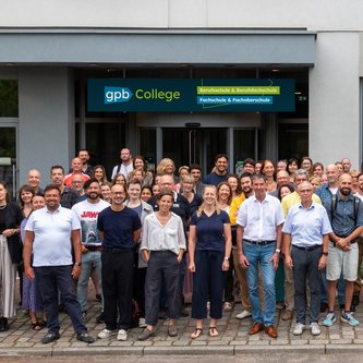 Mitarbeiter des GPB College vor dem Eingang am neuen Standort